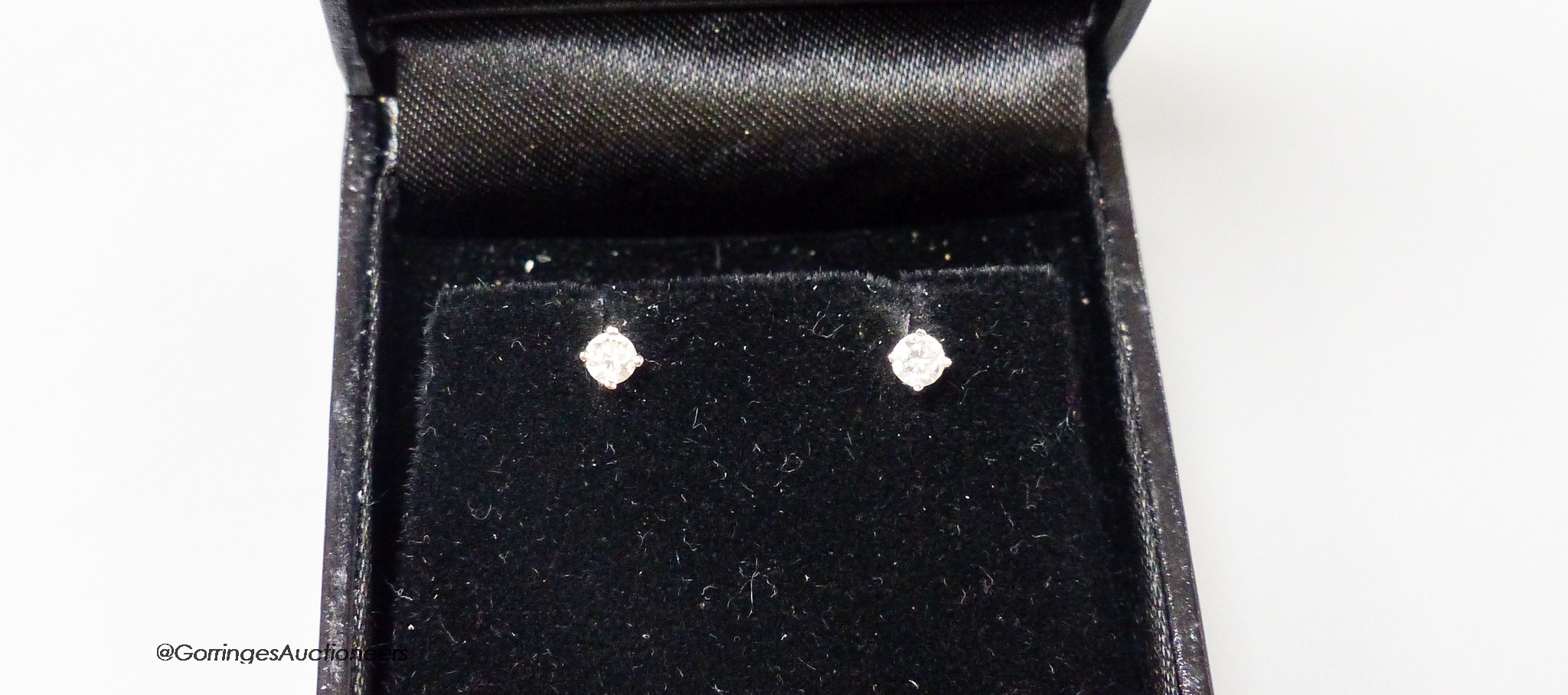 A modern pair of 18ct white gold and solitaire diamond set ear studs, gross weight 1.1 grams, each stone weighing approx.0.12ct.